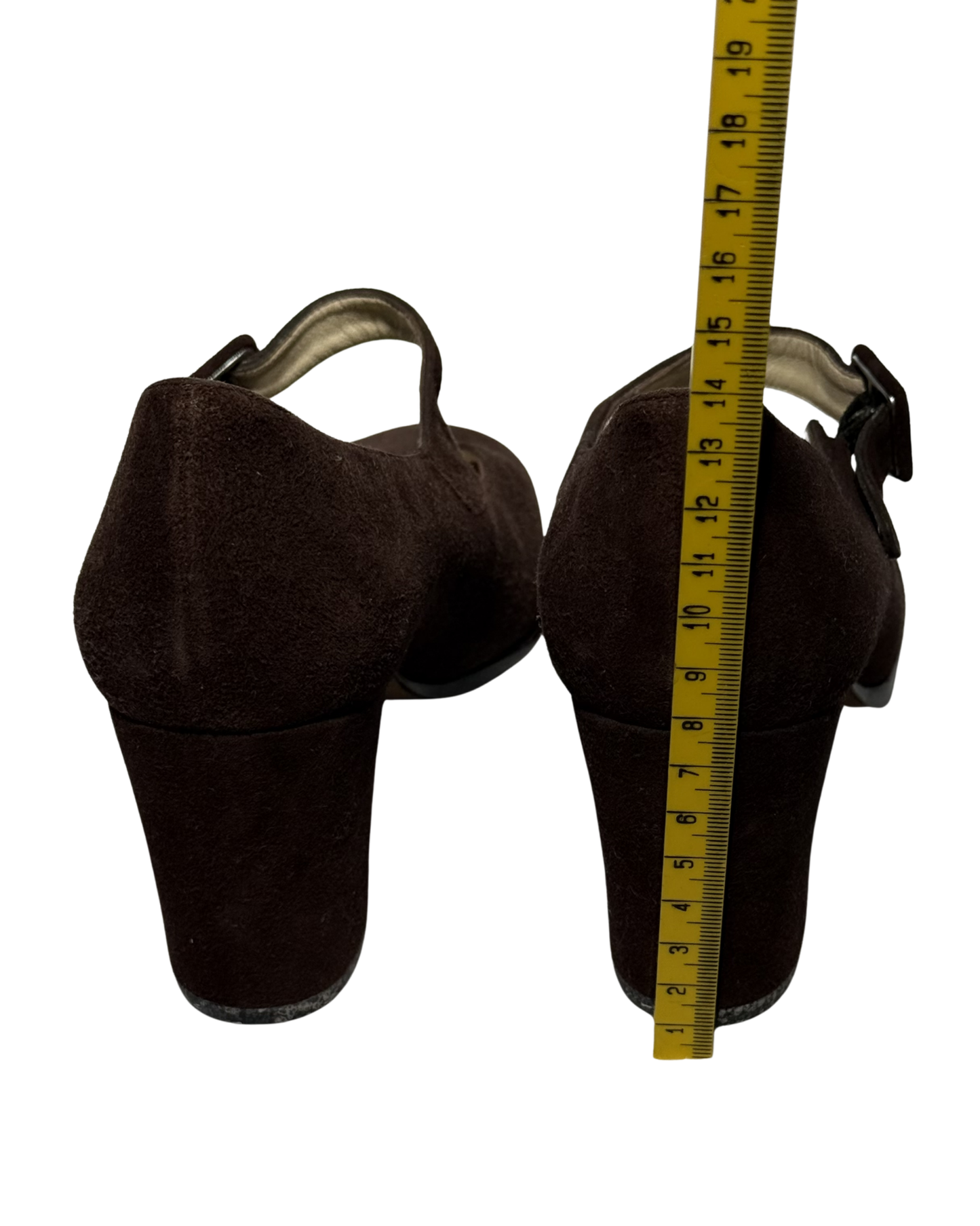 Two brown leather boot covers with a measuring tape on a white background