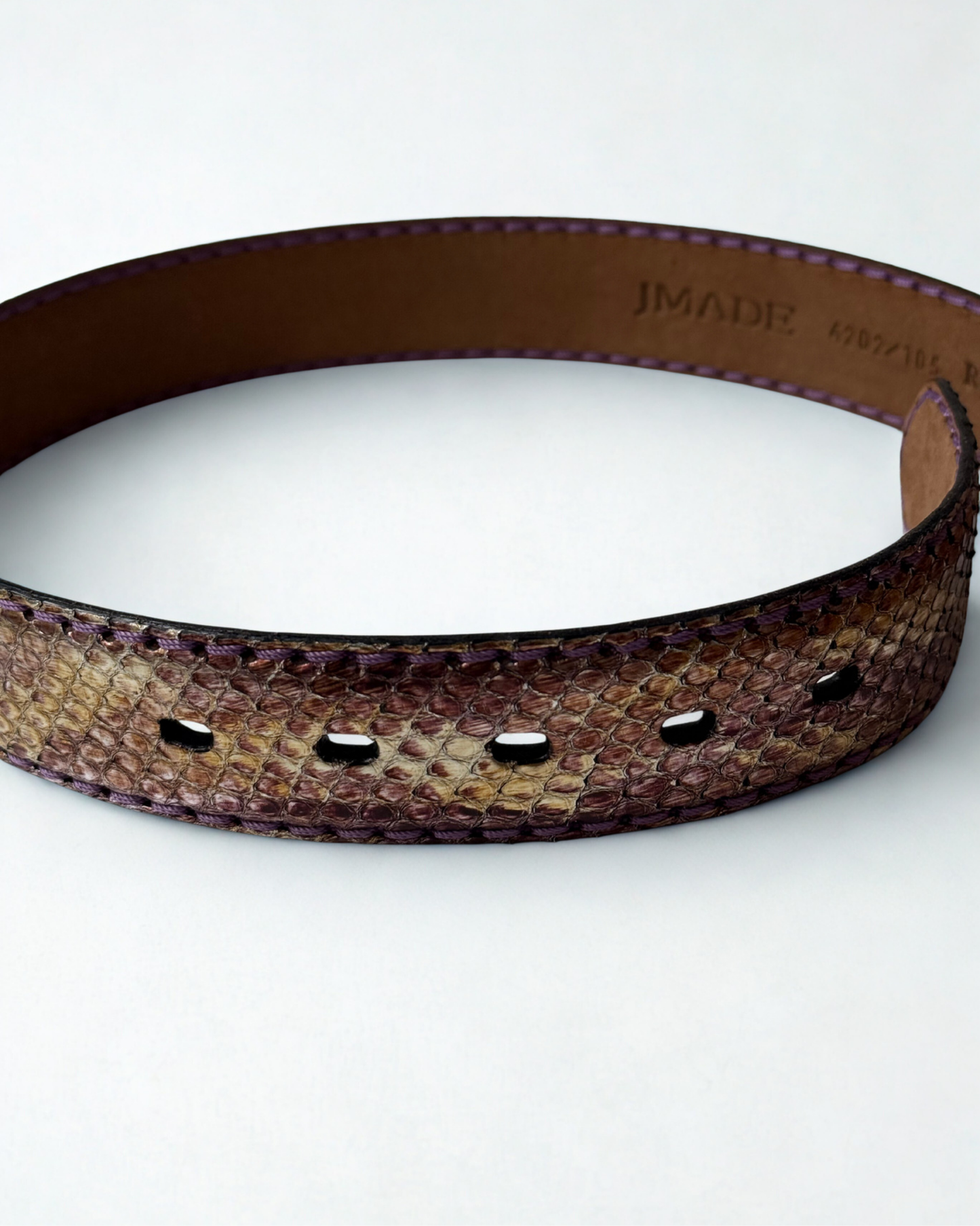 Close up of python leather texture on vintage JMADE belt in purple and gold