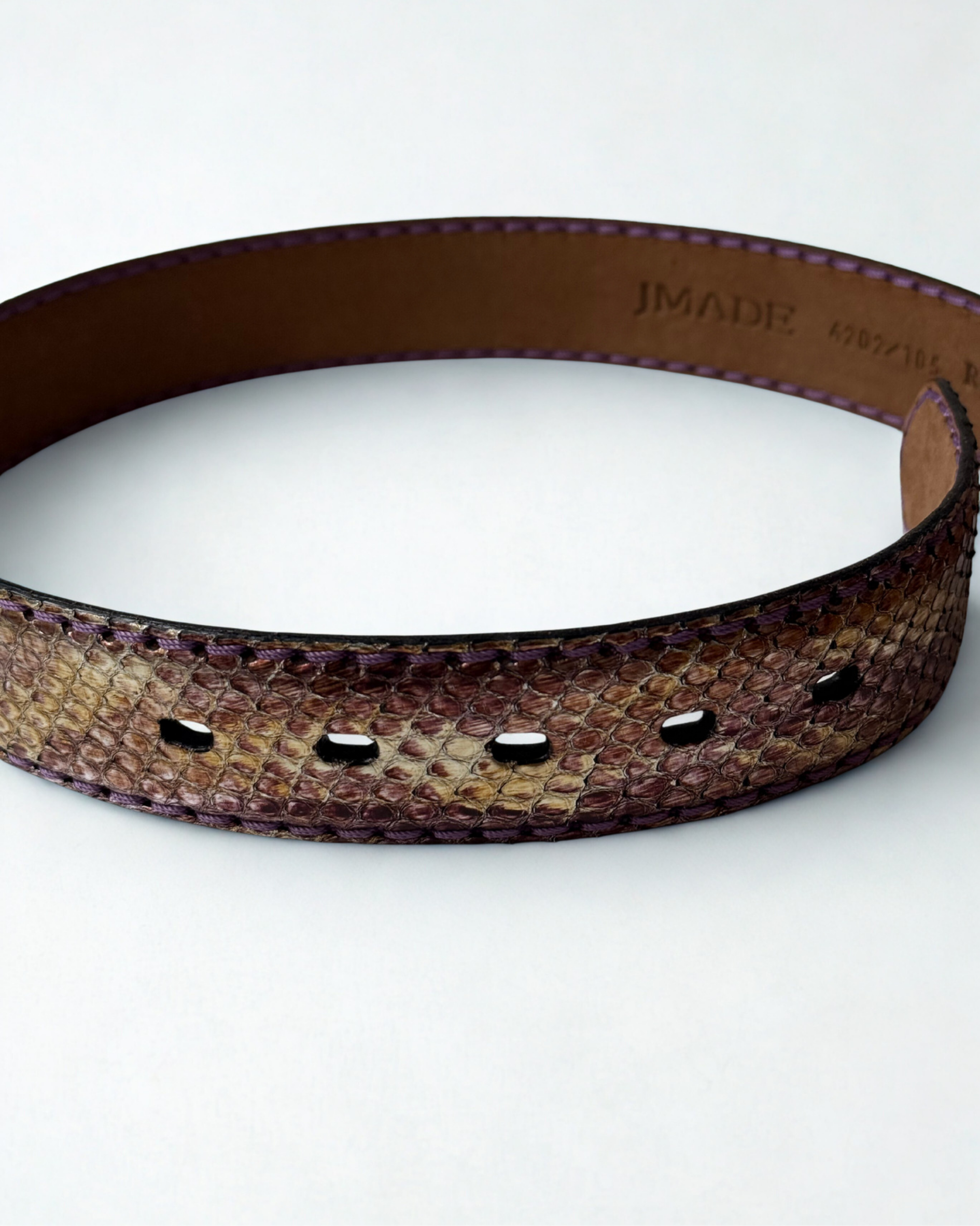 Close up of python leather texture on vintage JMADE belt in purple and gold