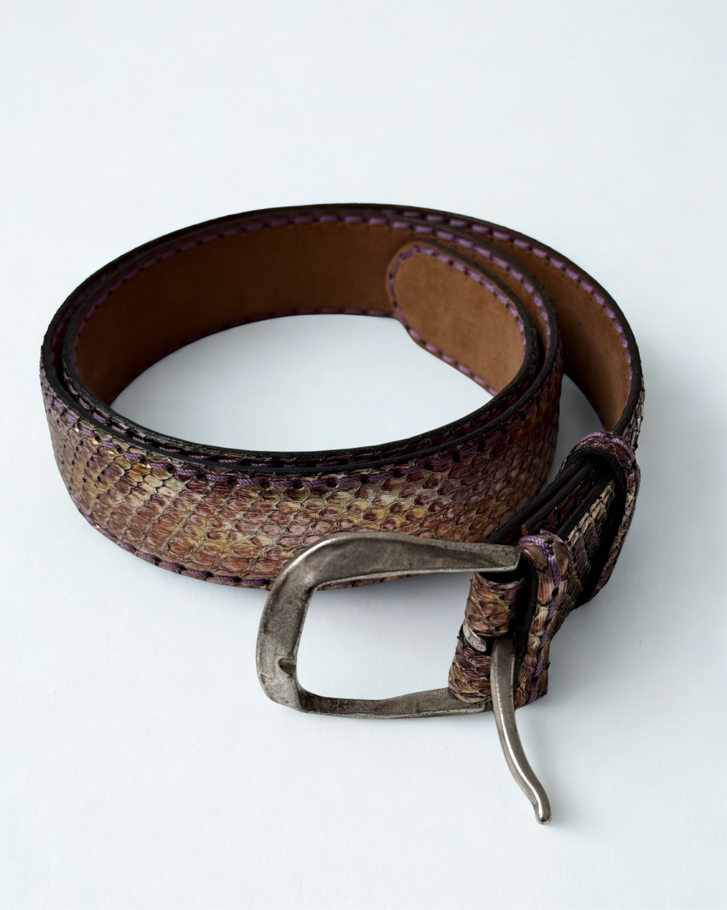 Close up of buckle on vintage JMADE belt in purple and gold