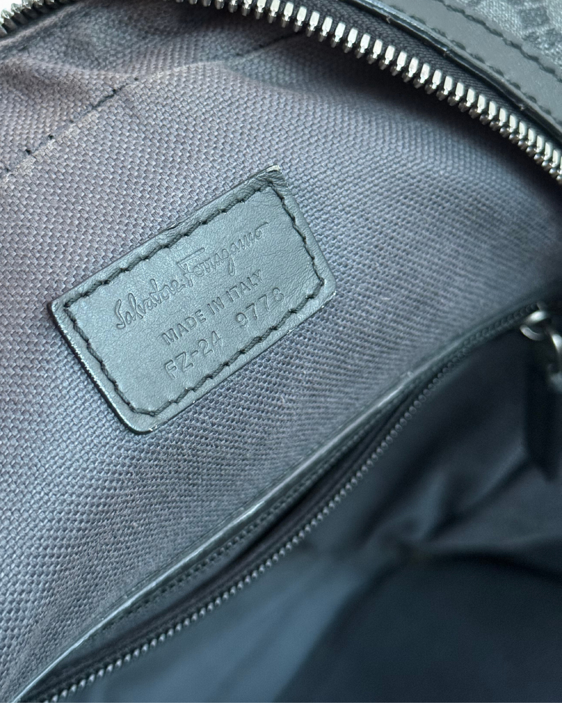 Close-up of Salvatore Ferragamo leather backpack with a Salvatore Ferragamo leather label 