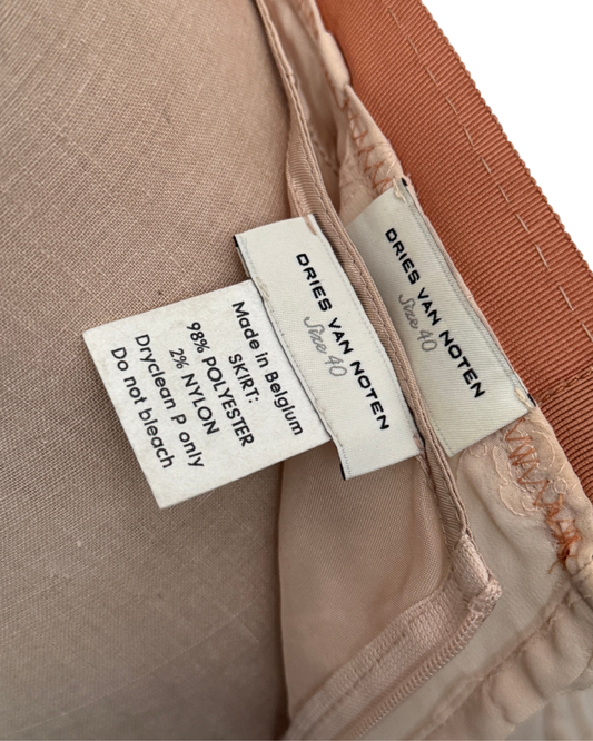 Close-up of Dries Van Noten label on a garment with fabric background