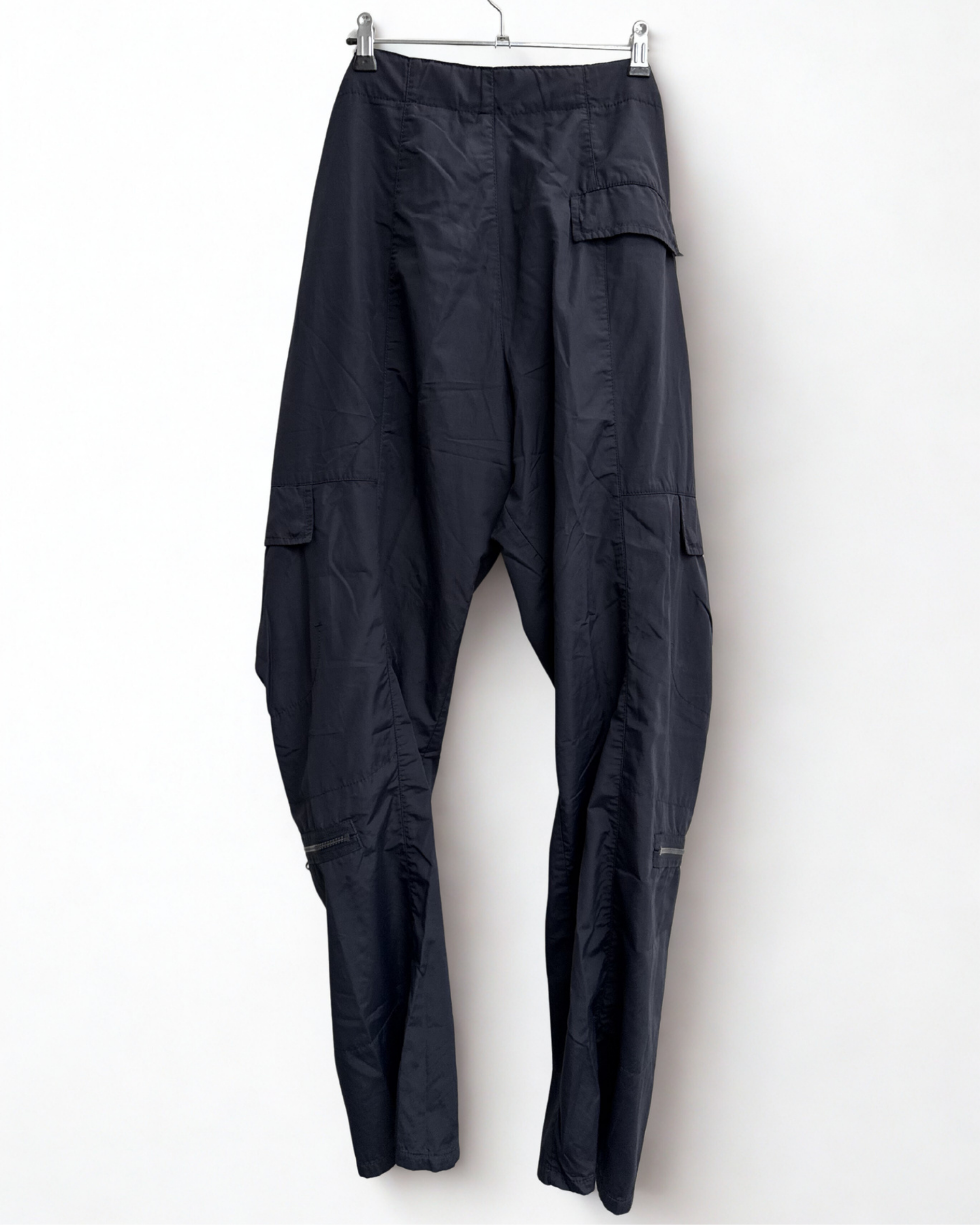 Backview of navy Girbaud cargo trousers hanging