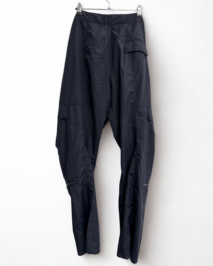 Backview of navy Girbaud cargo trousers hanging