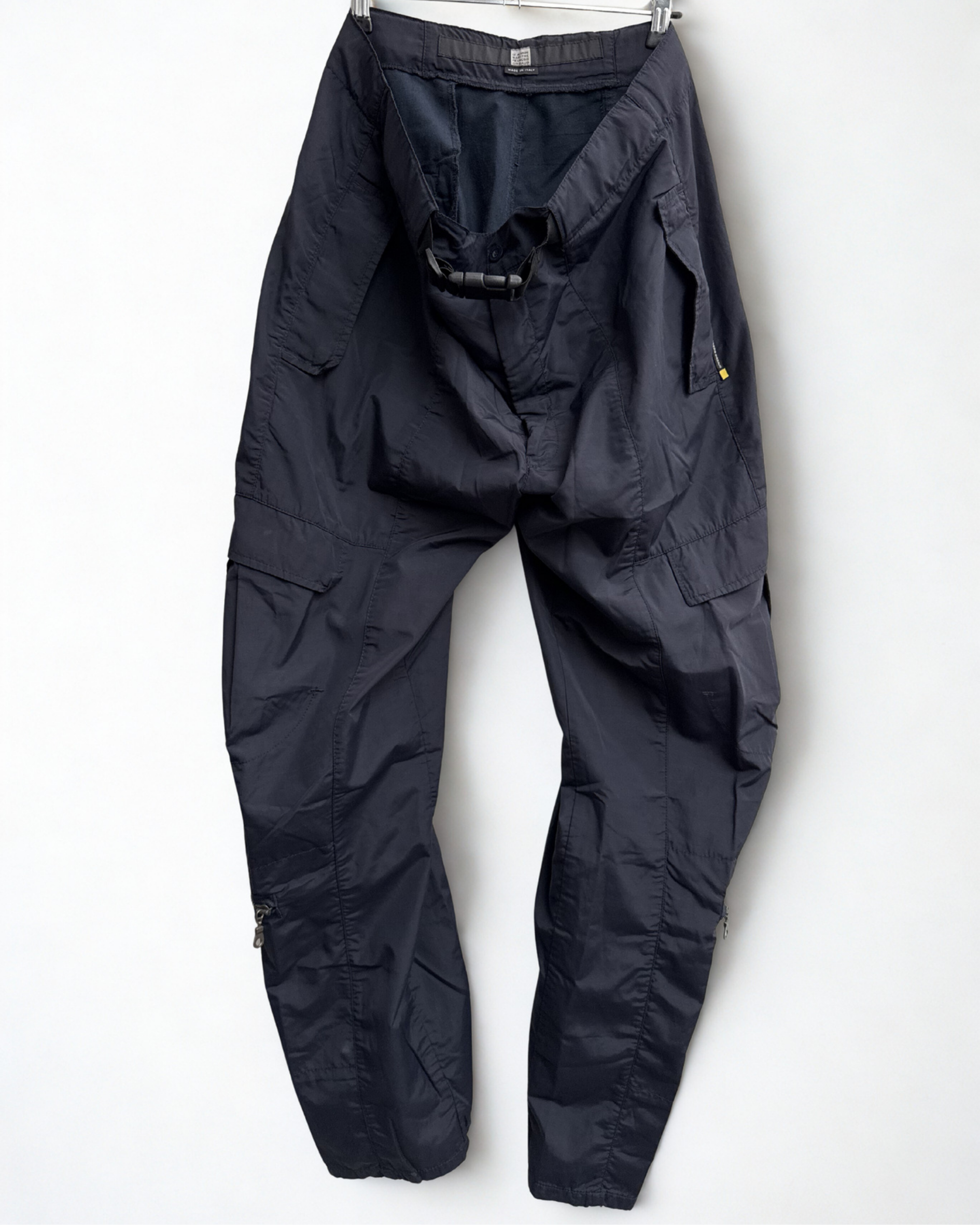 Front view of navy Girbaud cargo trousers hanging