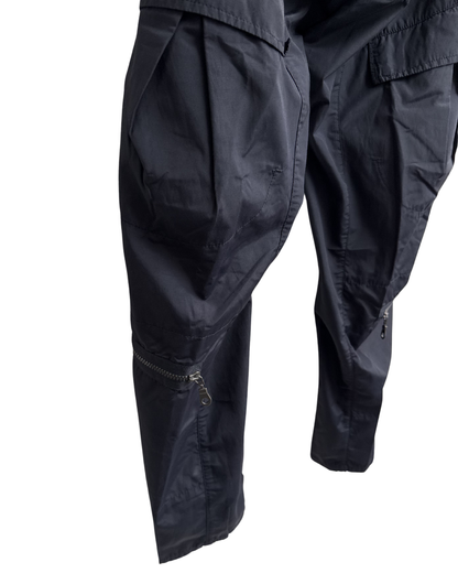 Navy cargo pants with zippers on a white background