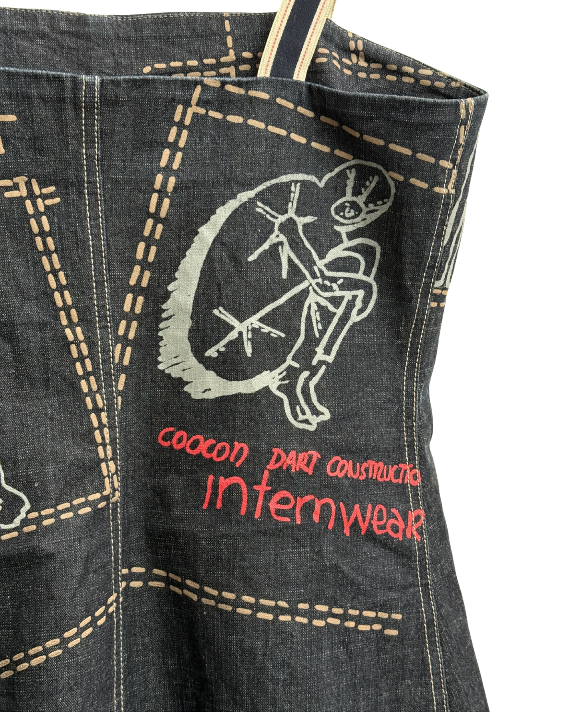Denim dress with embroidered design and text on a white background