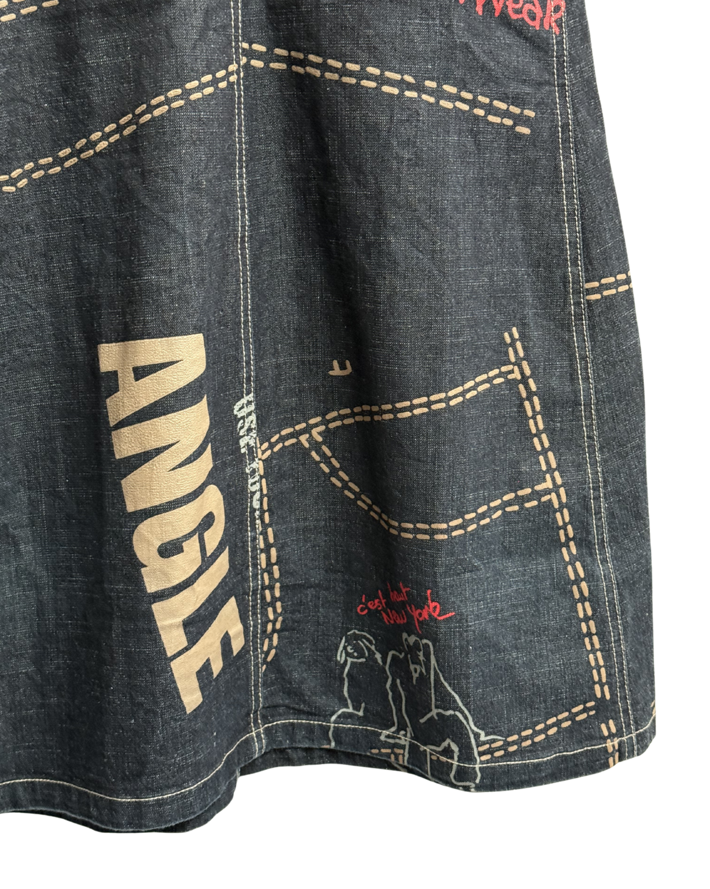 Close-up of a denim skirt with 'ANGLE' branding and a small graphic on a white background
