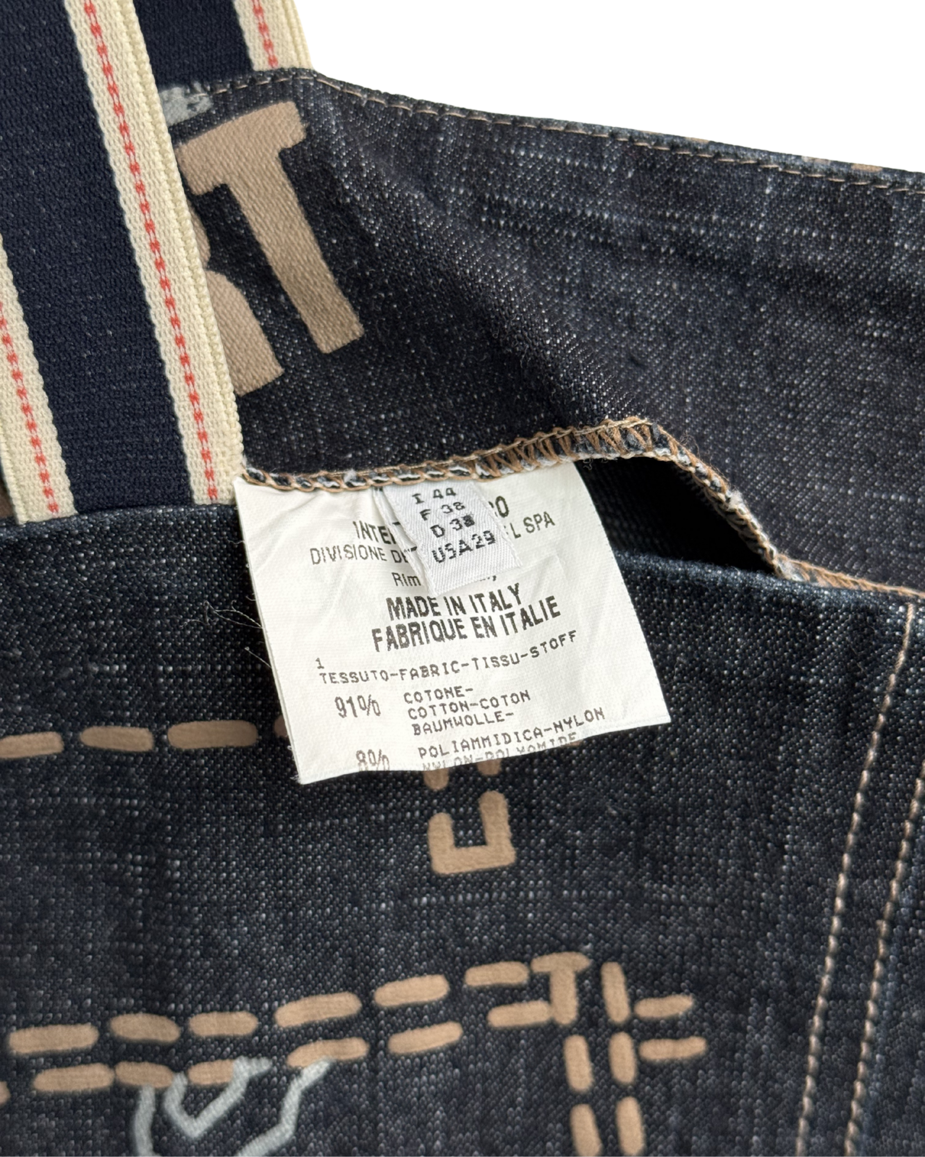 Close-up of a denim fabric with a label indicating 'Made in Italy'.