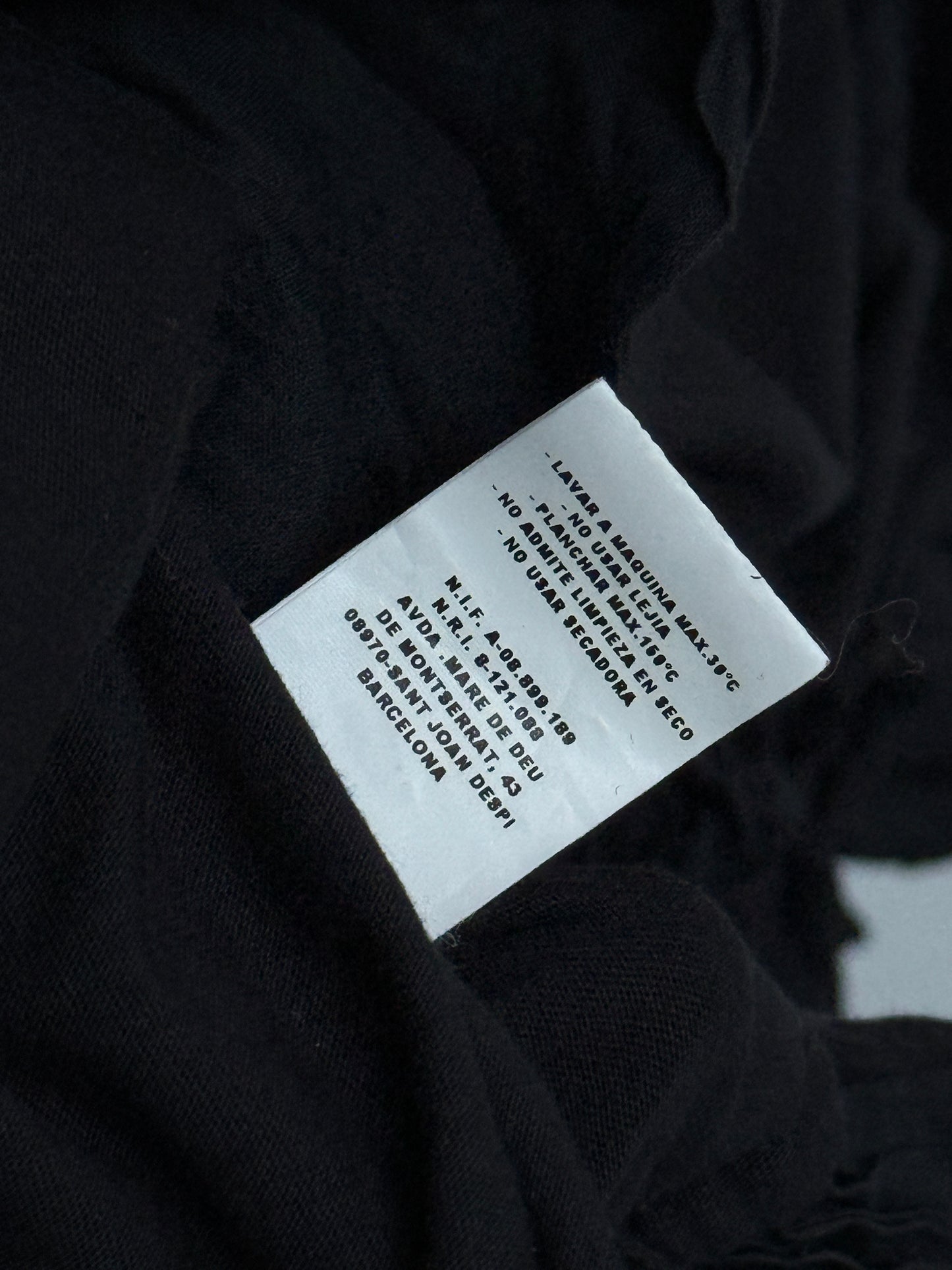 Clothing label on a black fabric background