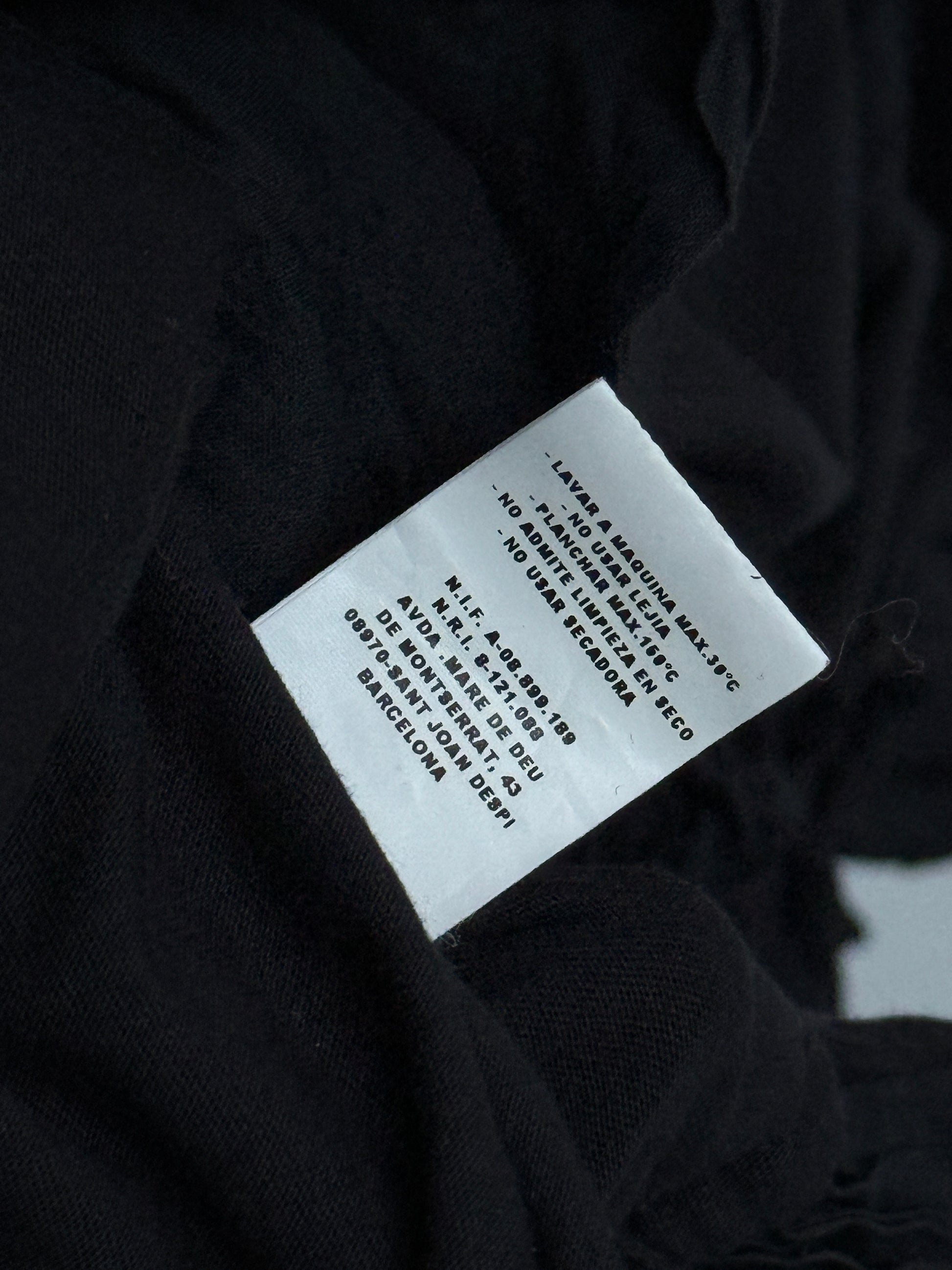 Clothing label on a black fabric background