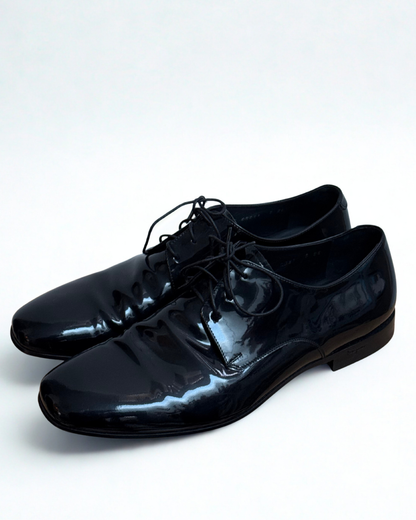 Side view of Salvatore Ferragamo black patent leather Oxford shoes