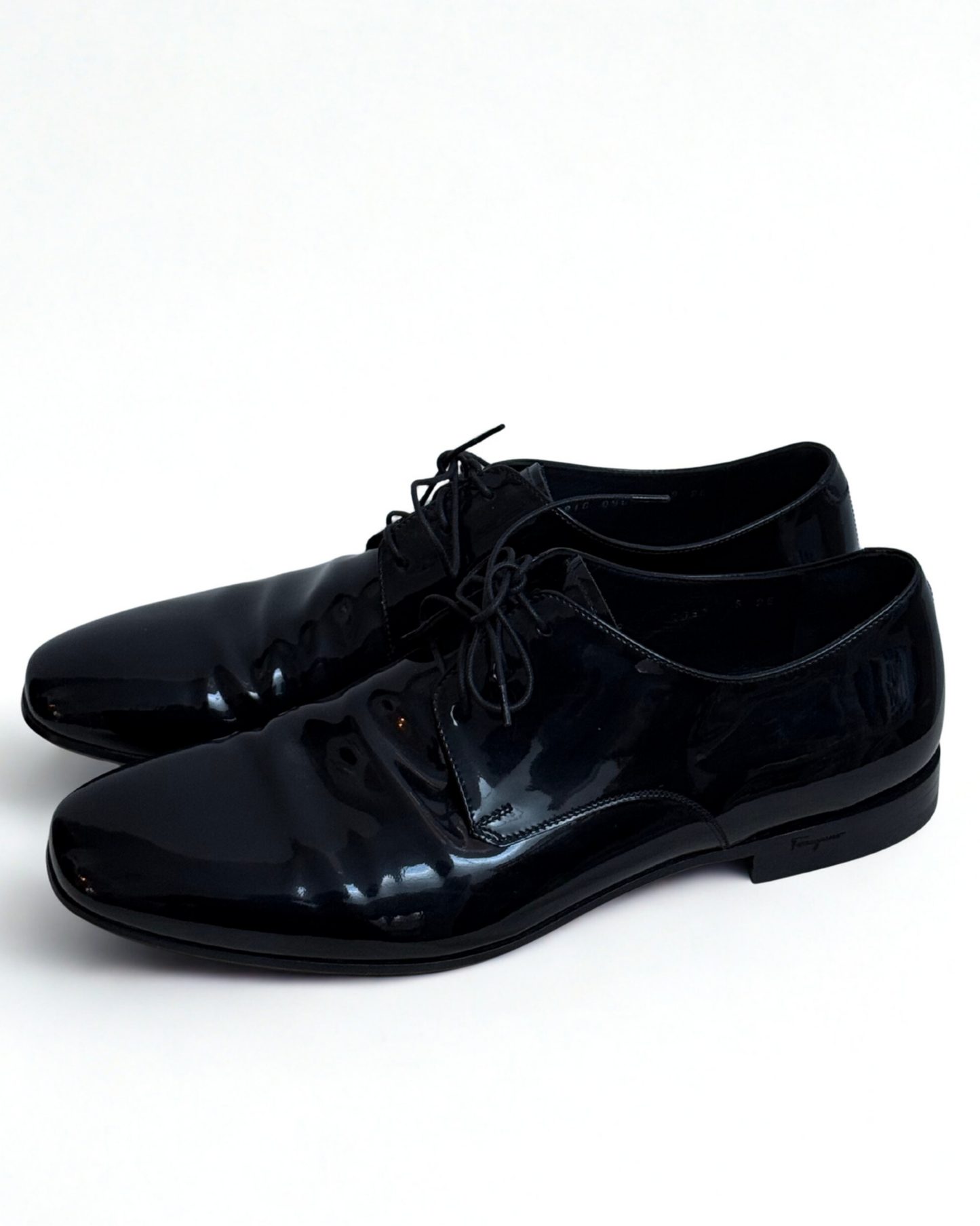 Side view of Salvatore Ferragamo black patent leather Oxford shoes