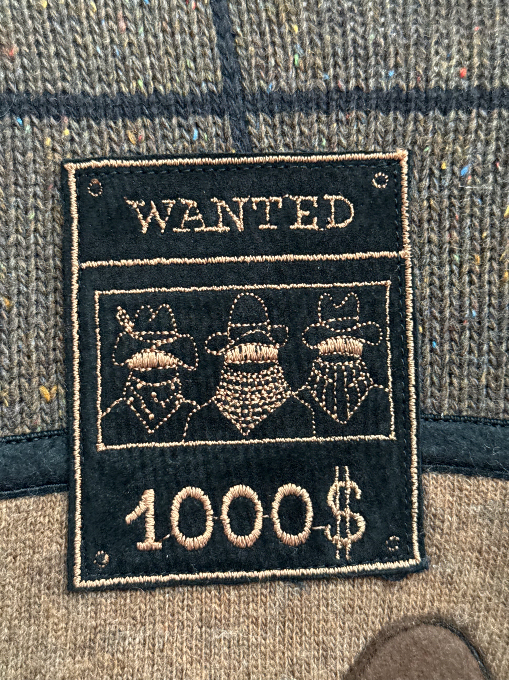 Close up of WANTED placard embroidery