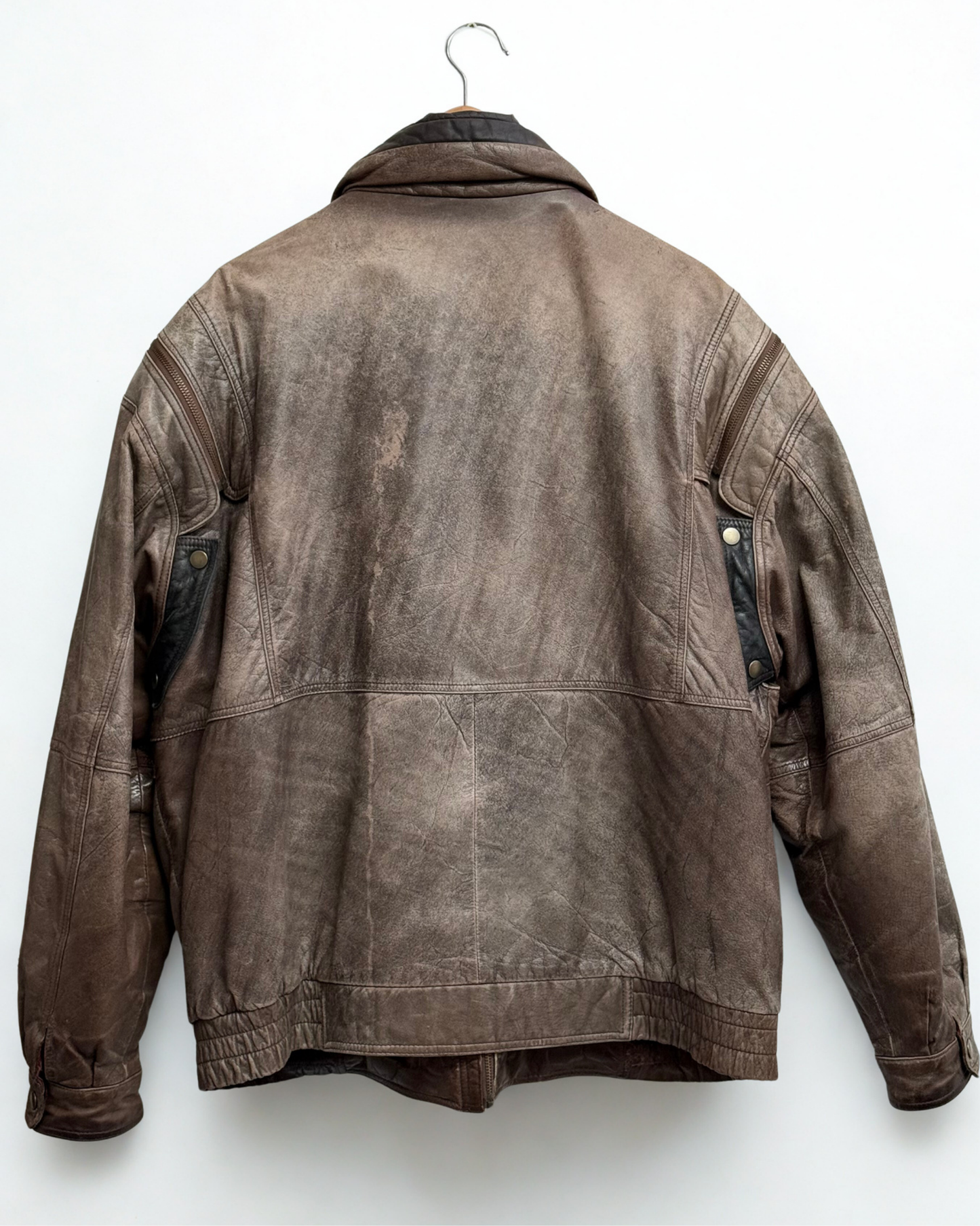 Back view of vintage leather bomber jacket showing structure