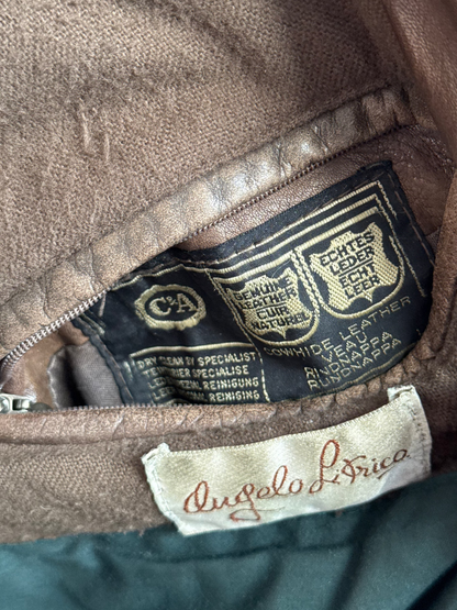 Close-up of a leather jacket with brand labels on the inside pocket.