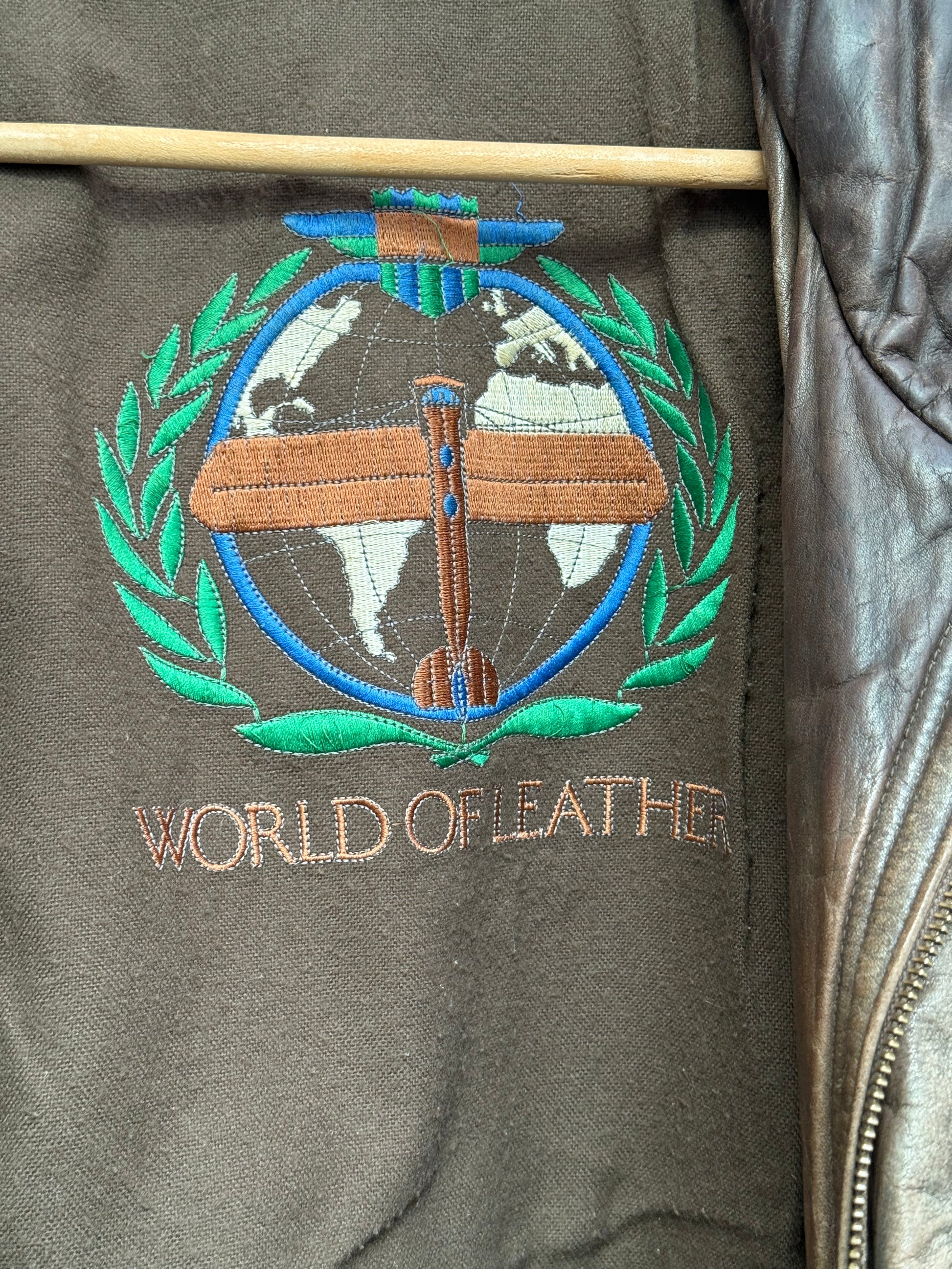 Close up of embroidered logo on vintage leather bomber jacket