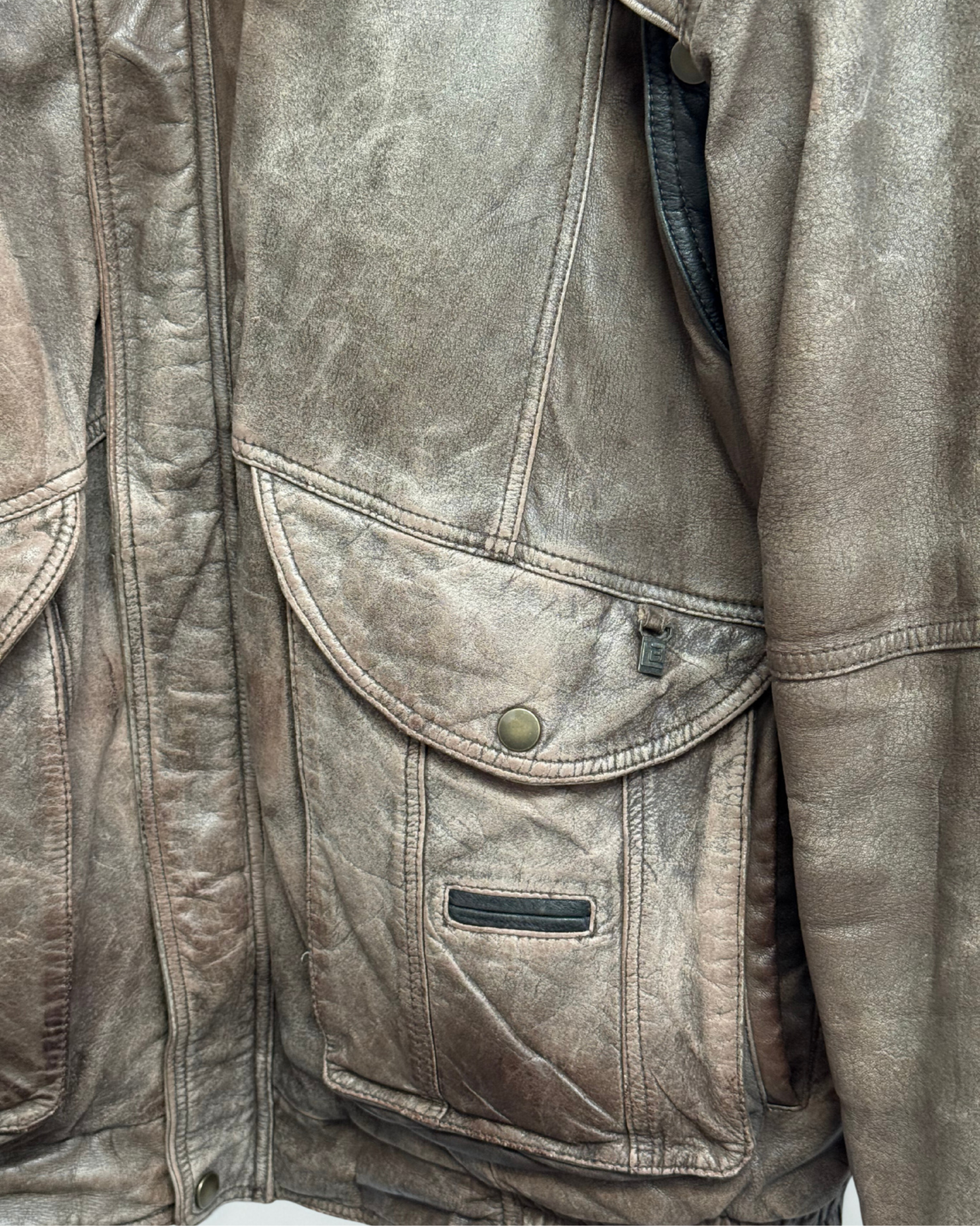Detail showing exterior wear on front left pocket of vintage 1980s leather bomber