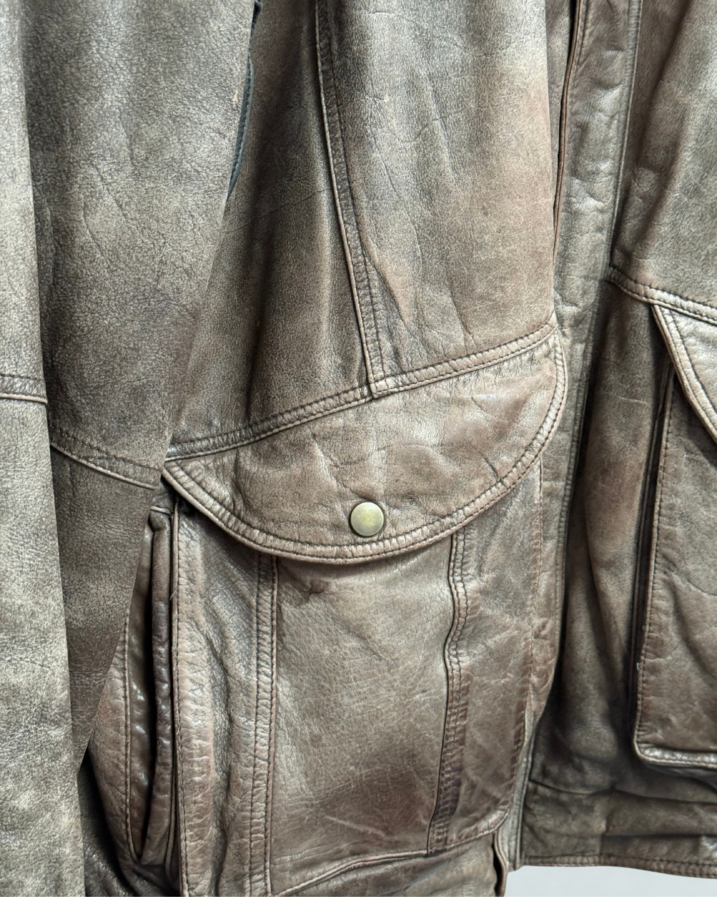 Detail showing exterior wear on front right pocket of vintage 1980s leather bomber