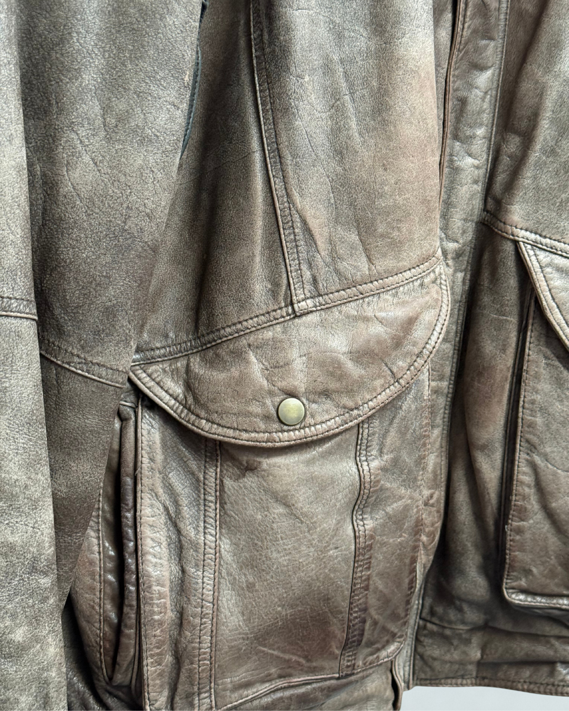 Detail showing exterior wear on front right pocket of vintage 1980s leather bomber