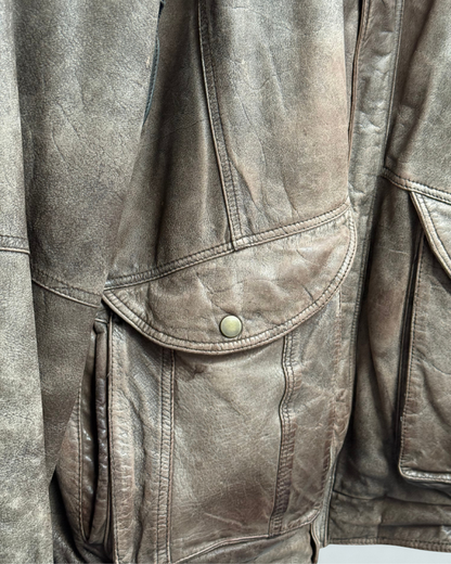 Detail showing exterior wear on front right pocket of vintage 1980s leather bomber