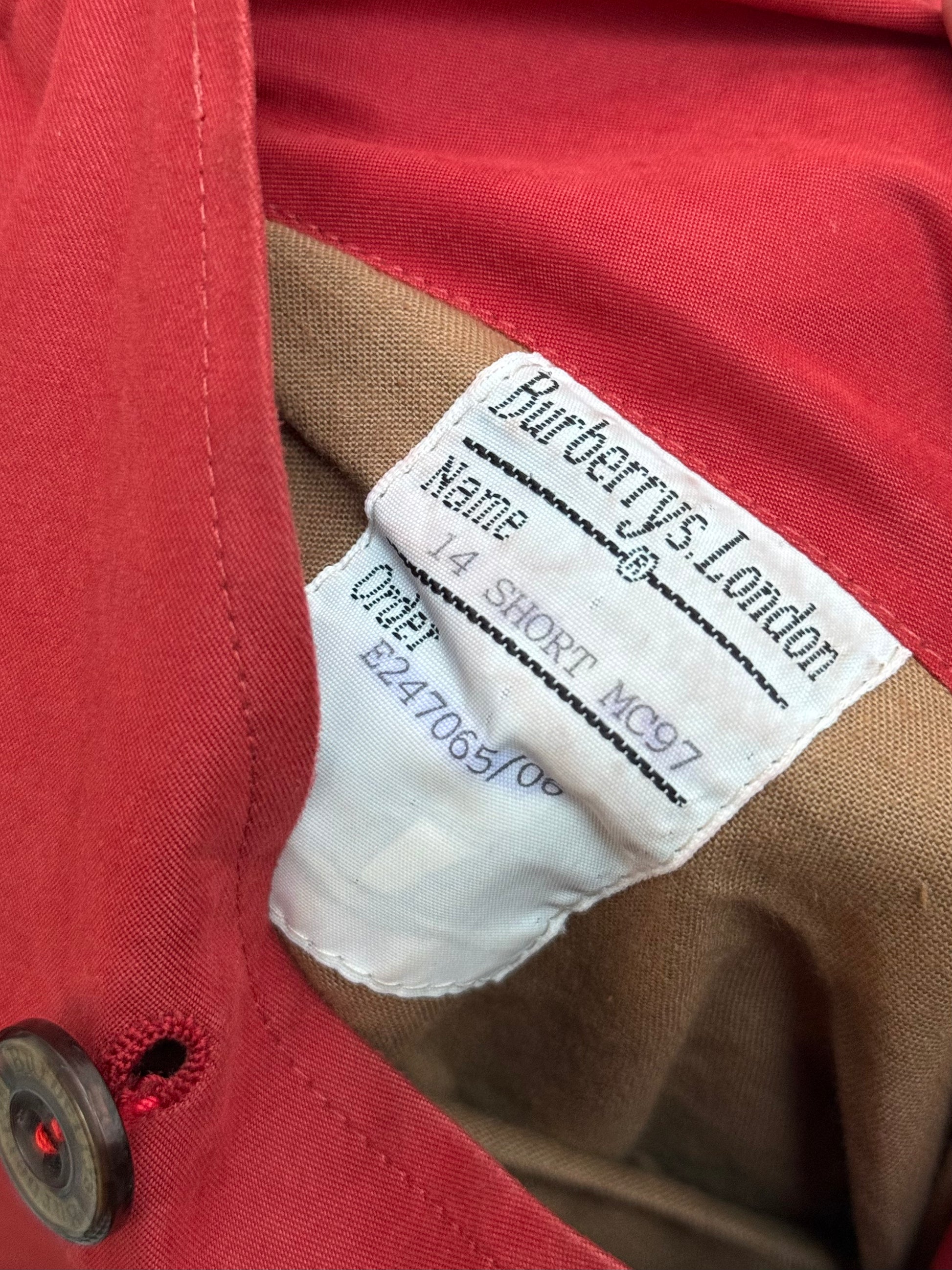 Close-up of a Burberry's London label on a red overcoat with Name and order number