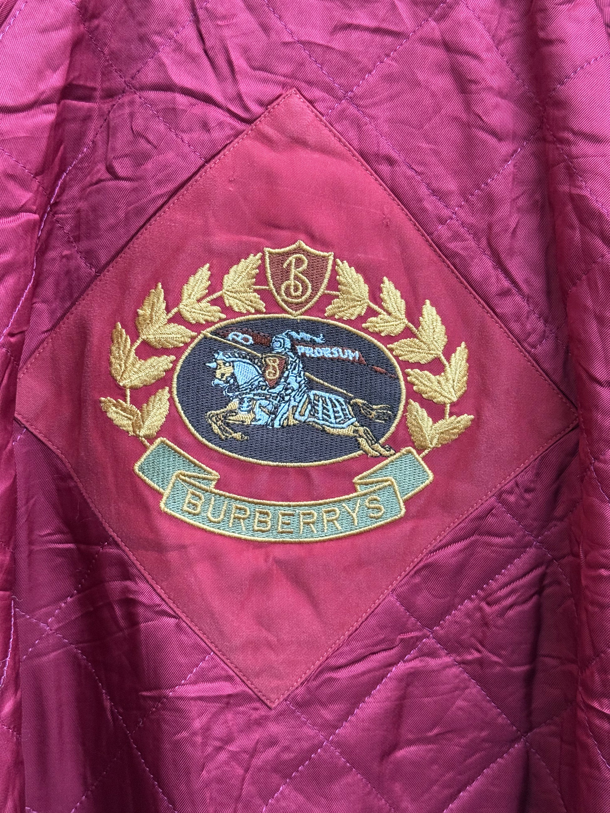 Close-up on vintage embroidery logo Burberry’s overcoat