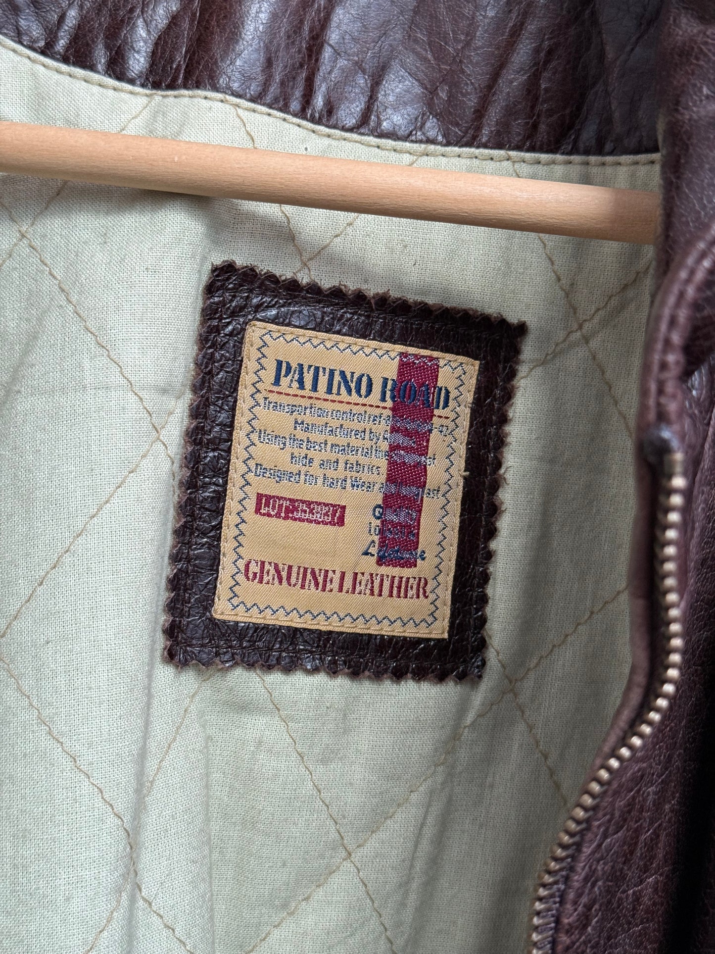 Patino Road brand label detail inside vintage leather overcoat