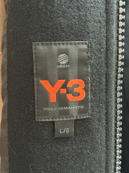 Close-up of a Y-3 label on a black fabric surface