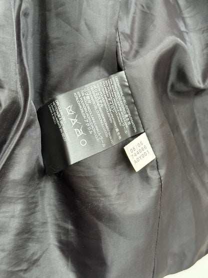 Clothing tag on a dark fabric surface