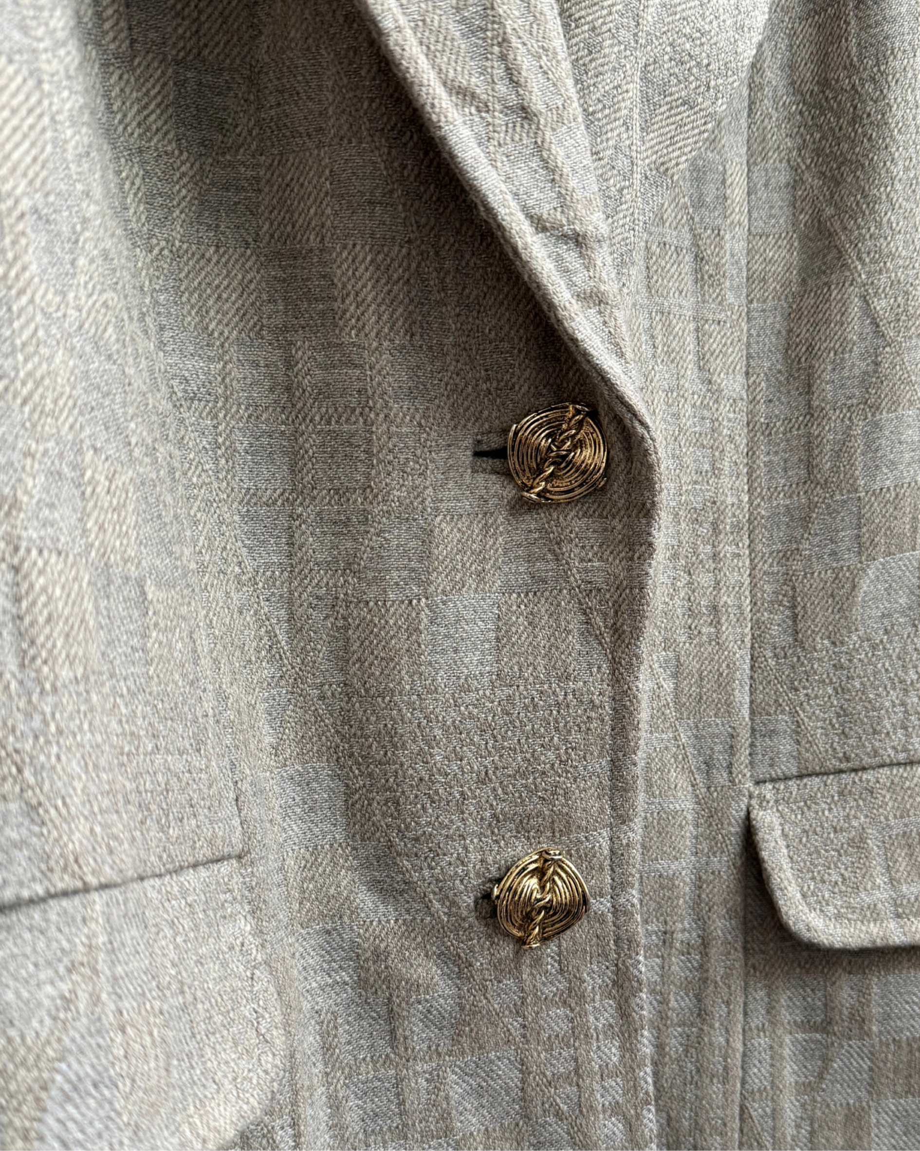 Gold button detail on vintage beige wool blazer