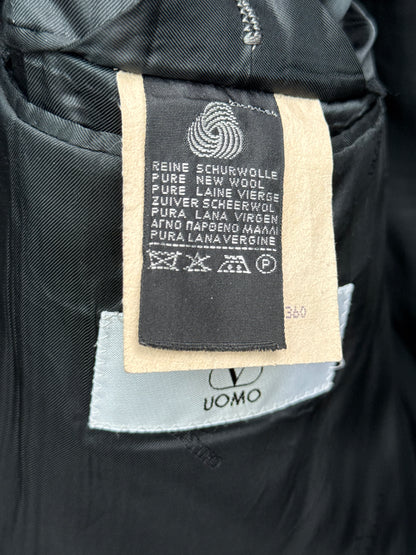 Woolmark label on a black garment with text and symbols.
