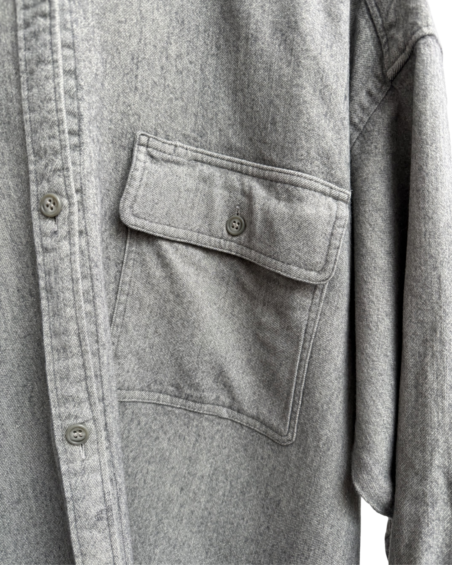 Close-up of a grey shirt with a pocket and buttons