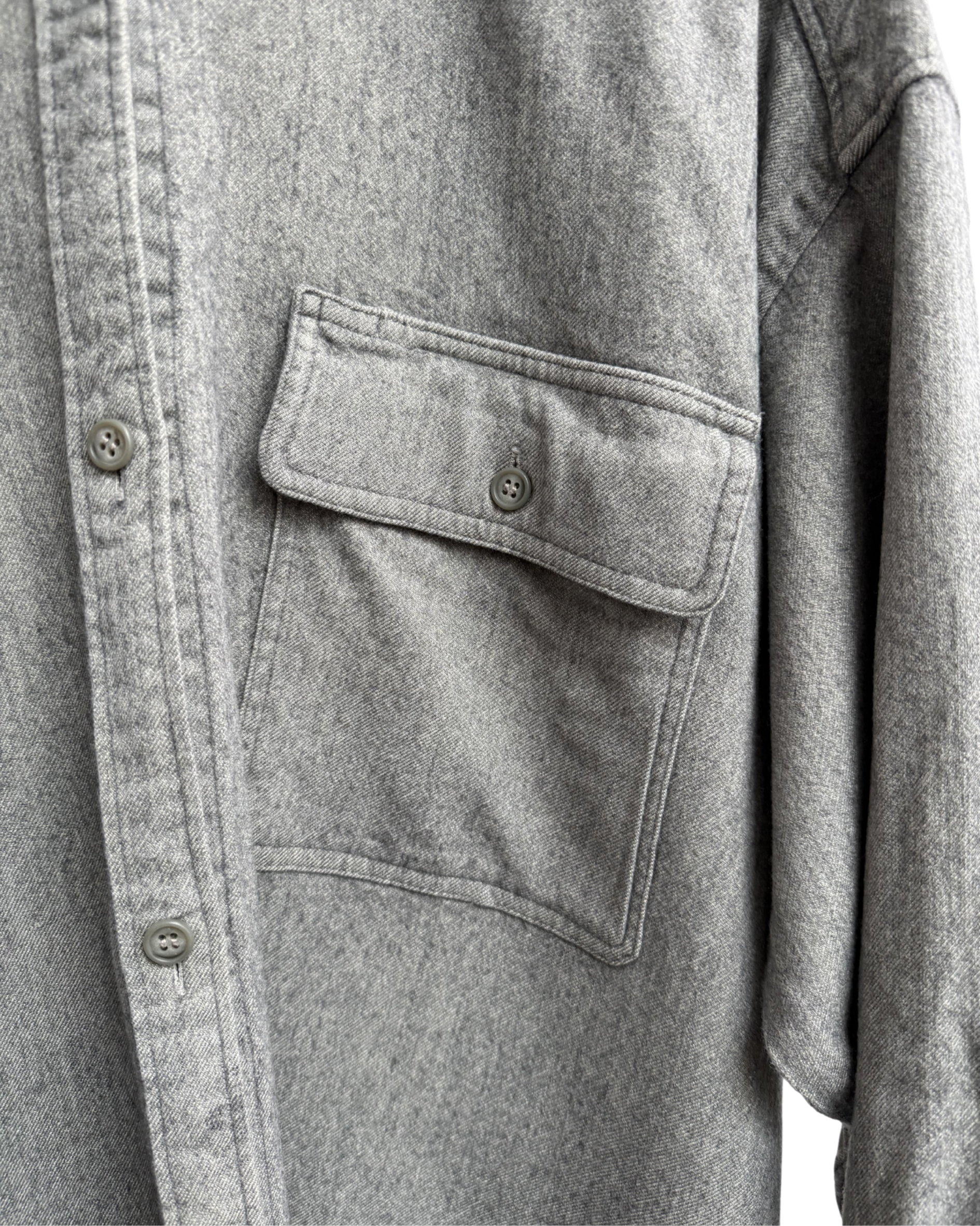 Close-up of a grey shirt with a pocket and buttons