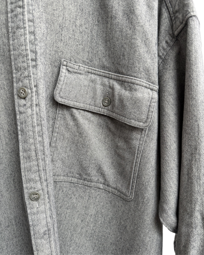 Close-up of a grey shirt with a pocket and buttons
