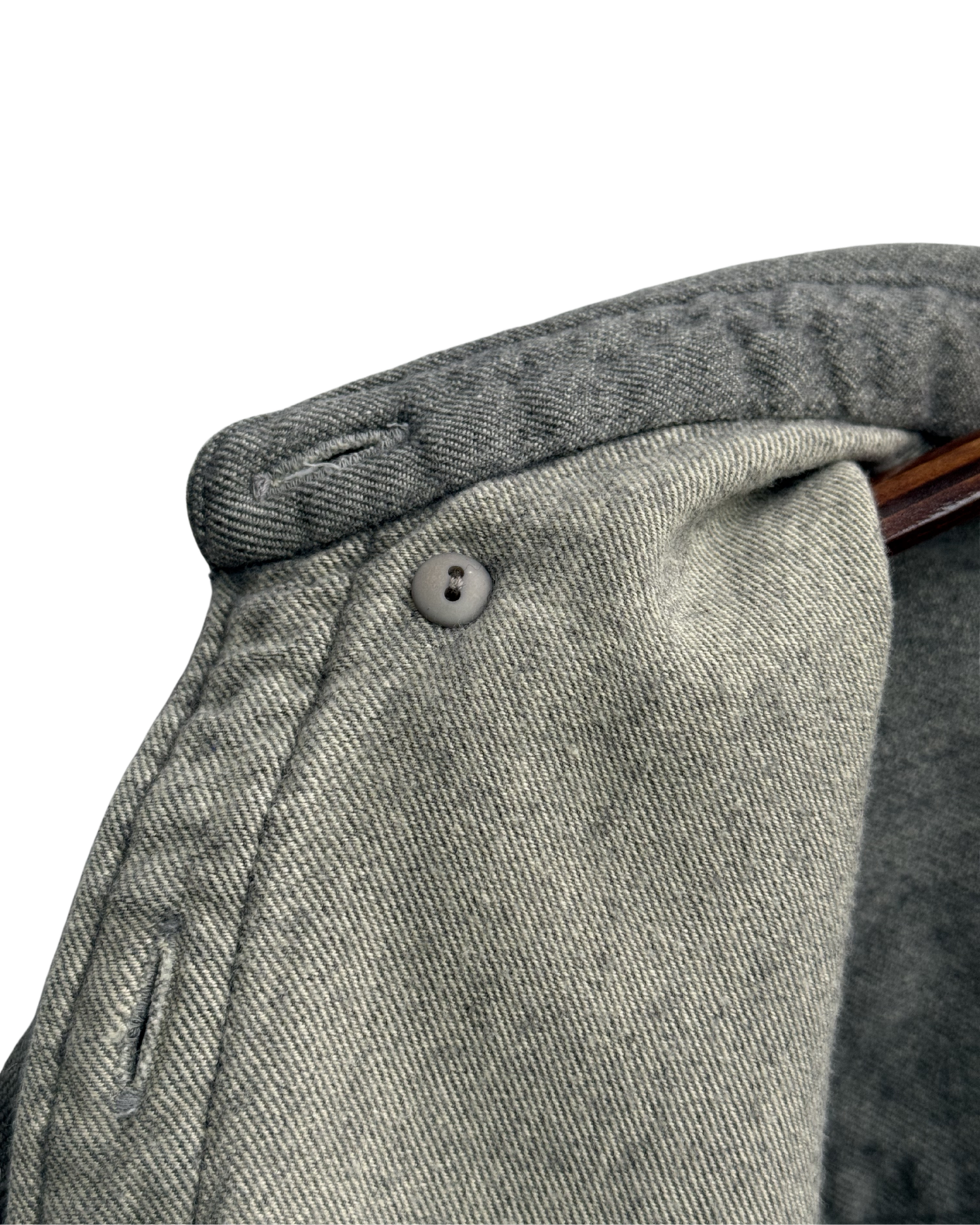 Close-up of inside button down collar on a grey shirt 