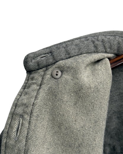 Close-up of inside button down collar on a grey shirt 