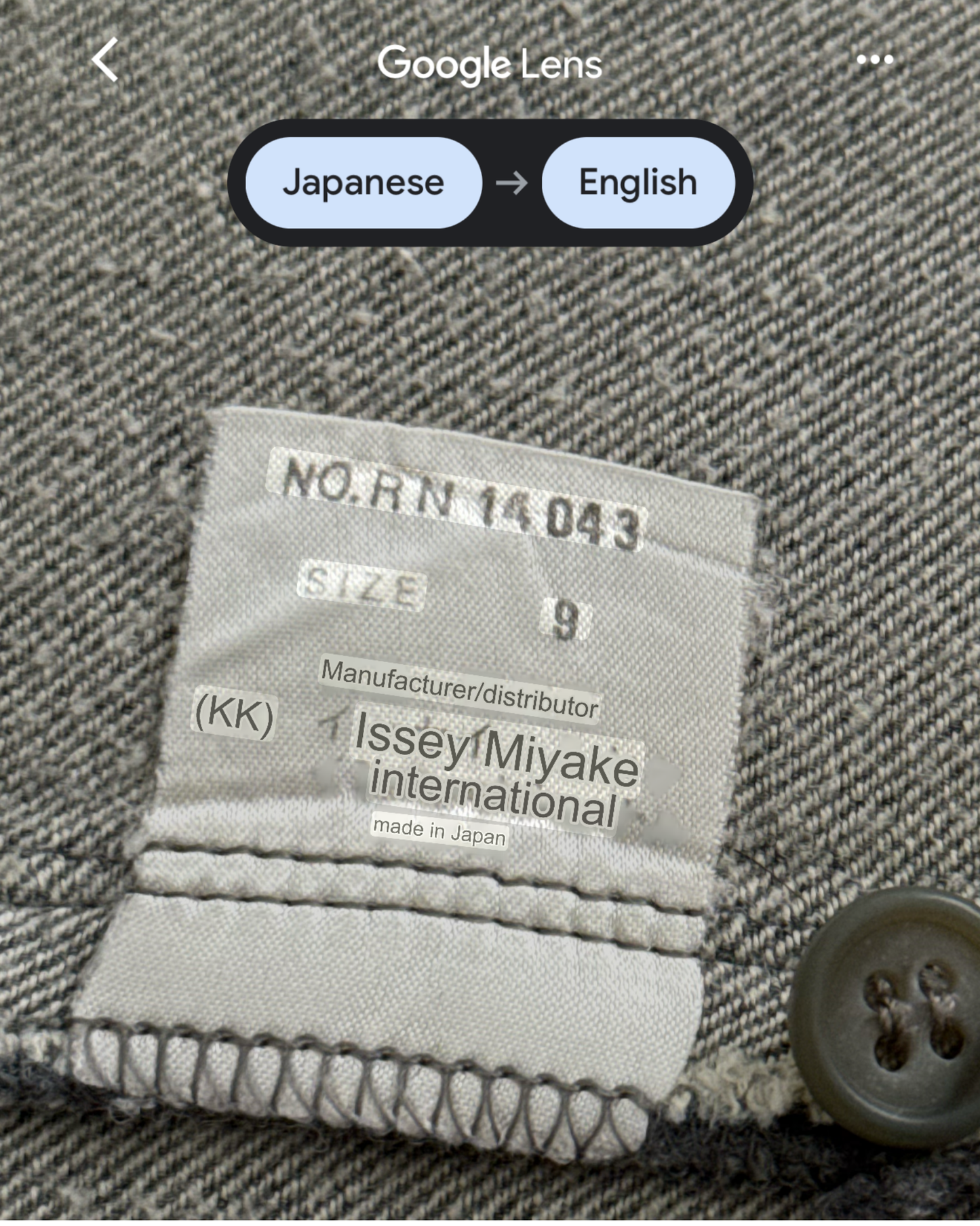 Label on a garment with text and a button, featuring 'Issey Miyake international' branding.