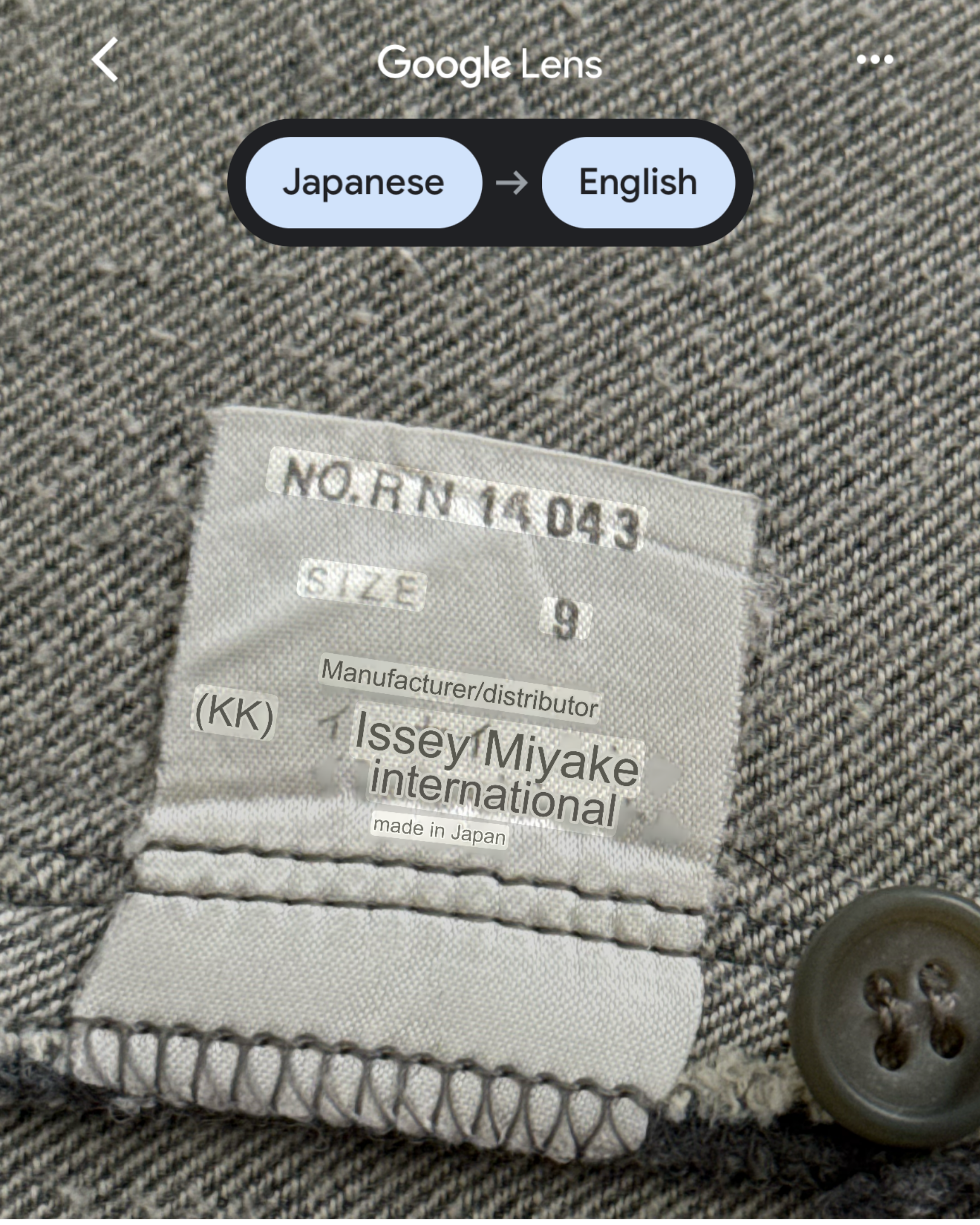 Label on a garment with text and a button, featuring 'Issey Miyake international' branding.
