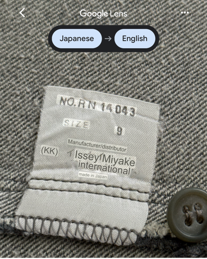Label on a garment with text and a button, featuring 'Issey Miyake international' branding.