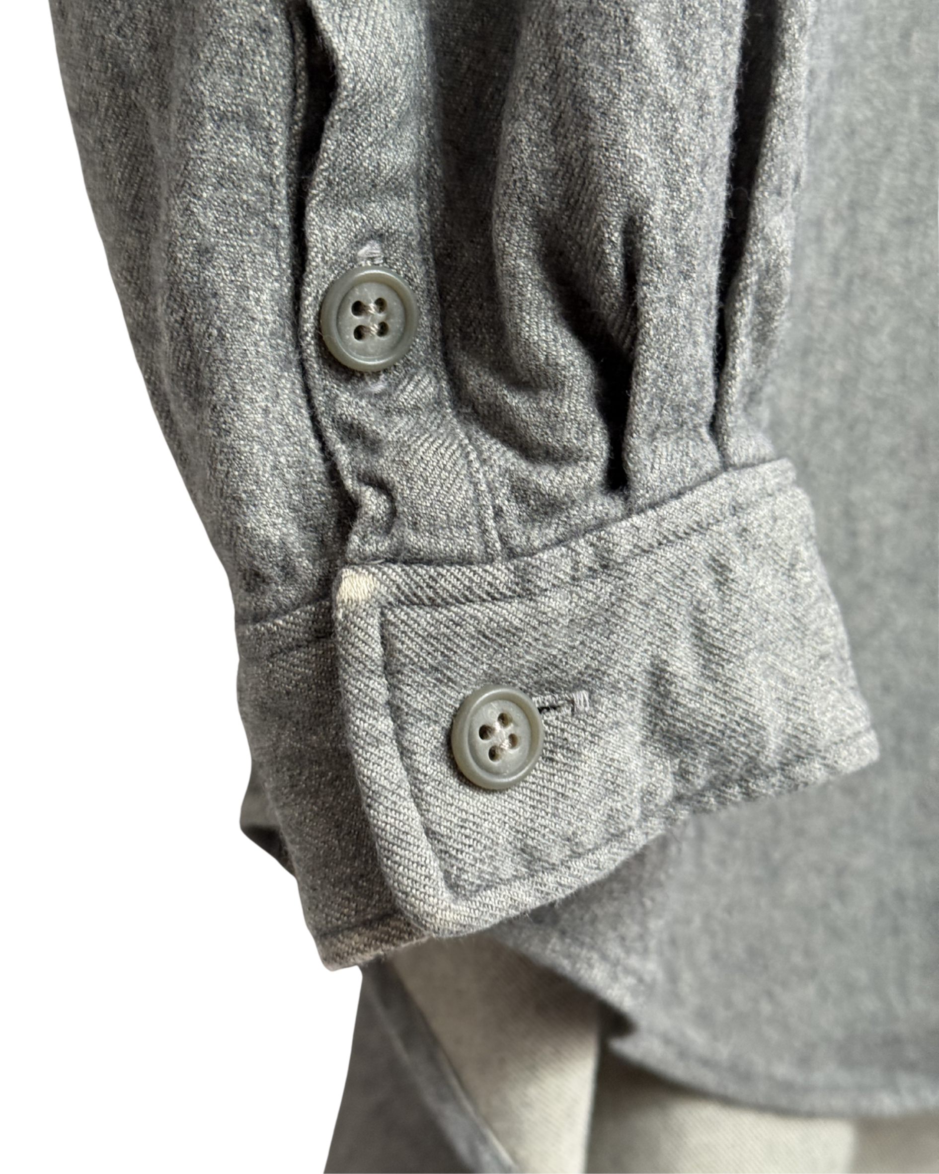 Close-up of a gray textured shirt with sleeves and buttons on a white background