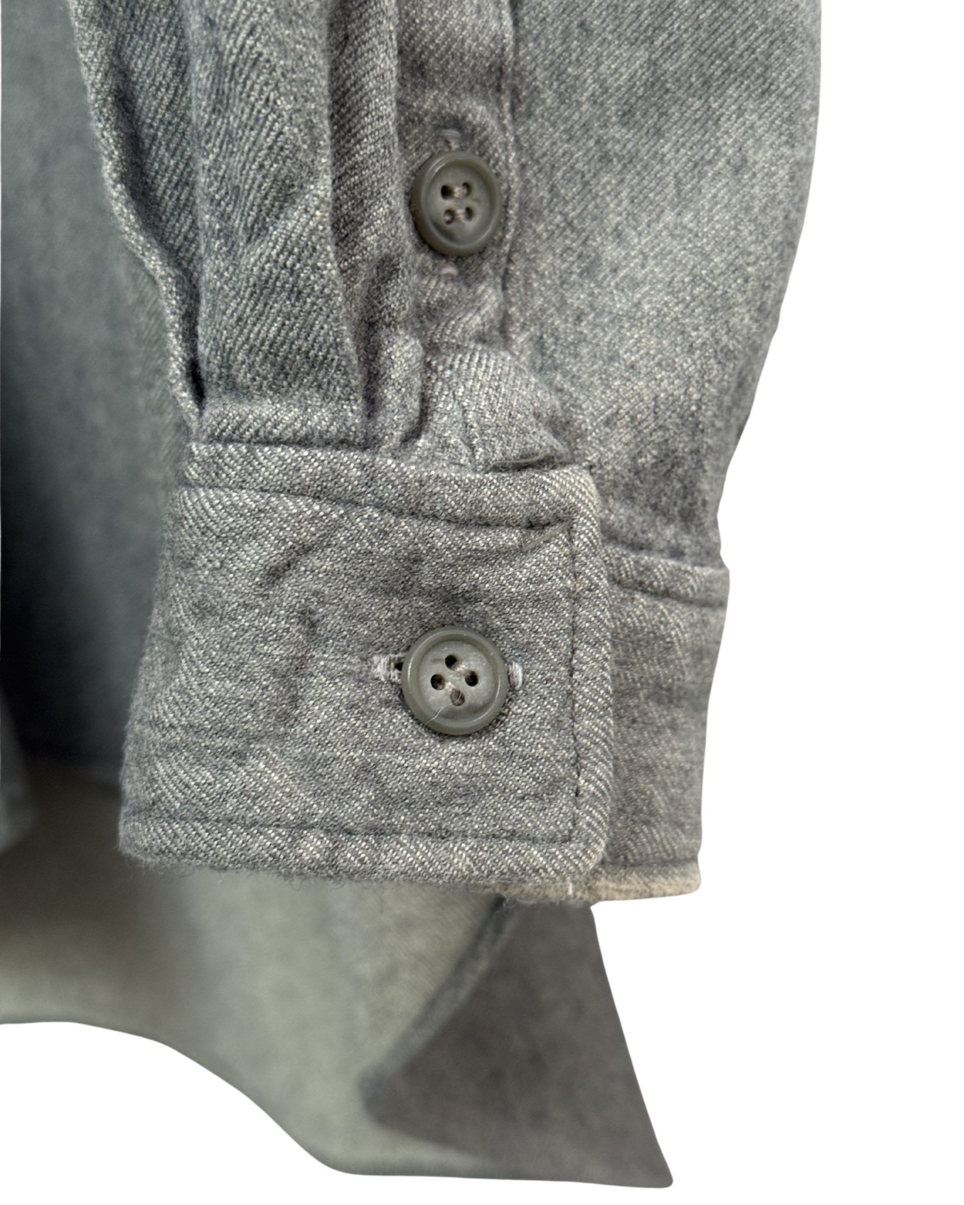 Close-up of a gray textured shirt with button details on a white background