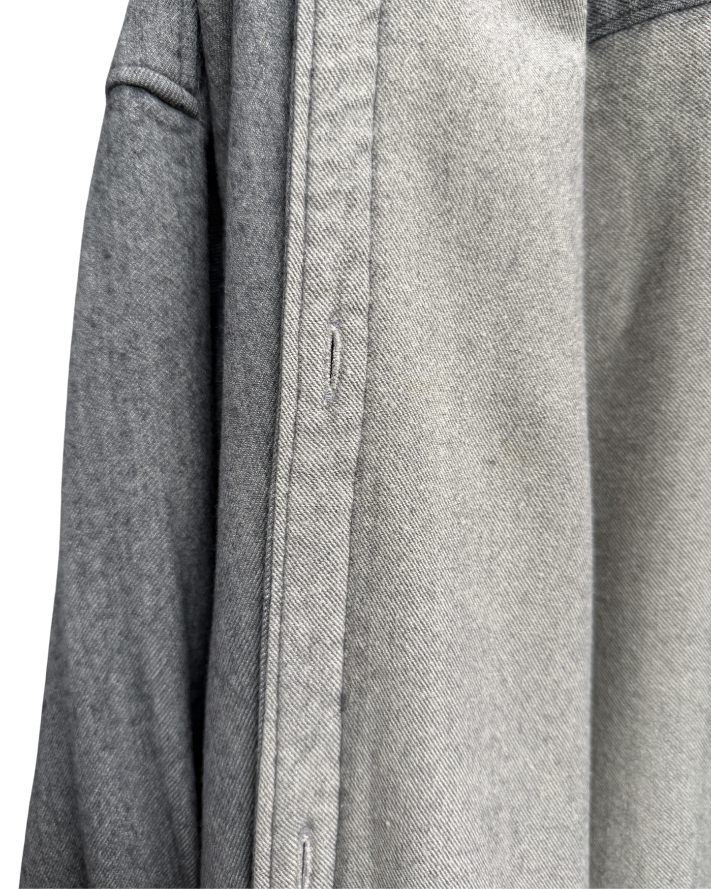 Close-up of a gray textured fabric with buttons on a white background